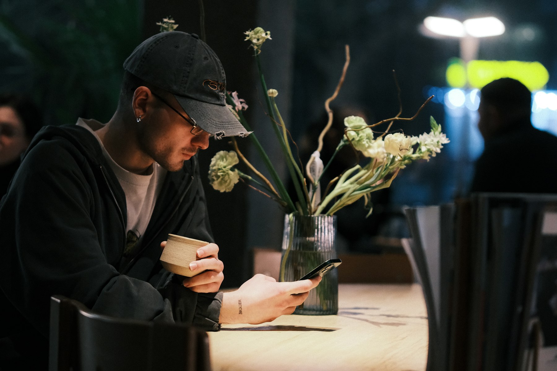 Man in a cafe looking at his phone